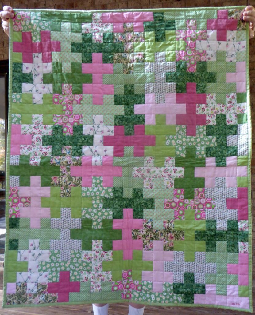 Jigsaw pattern in pink and green fabrics.